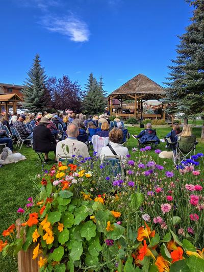 Bright summer flowers with gazebo in background