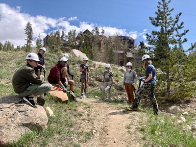 Volunteers doing trail work on a sunny spring day