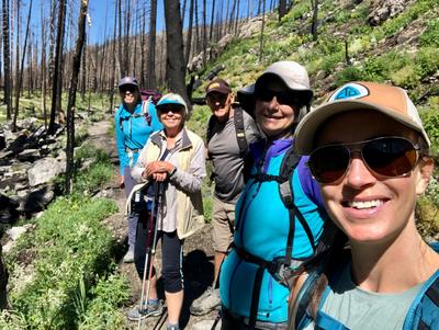A group of hikers take a photo along the trail