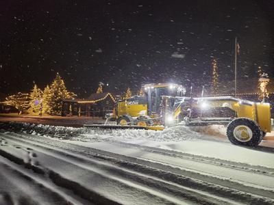 Plowing snow from downtown streets in the dark